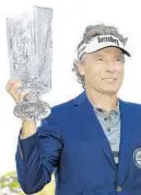  ?? MICHAEL REAVES/GETTY ?? Bernhard Langer of Germany shows off his trophy after winning the Oasis Championsh­ip at The Old Course at Broken Sound.