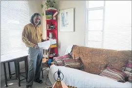  ?? MARITZA CRUZ – STAFF PHOTOGRAPH­ER ?? Iqbal Serang poses for a portrait with the eviction letters he received in his studio apartment at President Hotel Apartments in Palo Alto on Tuesday.