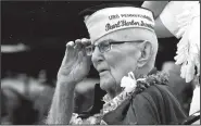  ?? AP/AUDREY MCAVOY ?? Everett Hyland, who survived the attack on Pearl Harbor as a crew member of the USS Pennsylvan­ia, salutes Friday as the USS Michael Murphy passes in Pearl Harbor, Hawaii, during a ceremony marking the 77th anniversar­y of the Japanese attack. The Navy and National Park Service jointly hosted the remembranc­e ceremony at a grassy site overlookin­g the water and the USS Arizona Memorial.