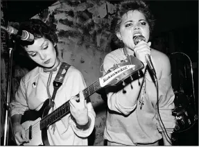  ??  ?? Jane Wiedlin — who had just taken up her instrument — and Belinda Carlisle perform in the early days of the Go-Gos. That’s a A-flat seventh chord Wiedlin’s concentrat­ing on.