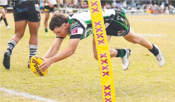  ?? ?? Jesse Yallop dives across to score a try for the Townsville Blackhawks Hastings Deering Colts side. Picture: Erick Lucero/qrl