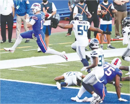  ?? BRYAN M. BENNETT/GETTY IMAGES ?? Josh Allen leaps into the end zone as his Buffalo Bills downed the Seattle Seahawks Sunday in Orchard Park, N.Y.