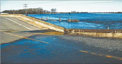  ?? NATI HARNIK/AP ?? Nebraska suffered about $435 million in damage to public infrastruc­ture from a March storm. Above, a downed bridge near Norfolk, Neb.