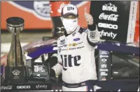  ?? The Associated Press ?? MASKED WINNER: Brad Keselowski celebrates after winning the NASCAR Cup Series race at Charlotte Motor Speedway early Monday in Concord, N.C.