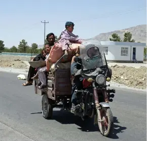  ??  ?? ● An Afghan family flees fighting as Afghan security personnel took back control of parts of Herat following fighting with Taliban forces