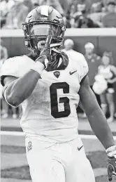  ?? [PHOTO BY NATE BILLINGS, THE OKLAHOMAN] ?? TCU tailback Darius Anderson tells the Stillwater crowd to sush after scoring the game’s final touchdown in the Horned Frogs’ 44-31 victory on Sept. 23.