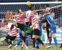  ??  ?? PENNED IN: Billericay’s Adam Pennington (no. 14) heads over