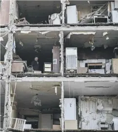  ?? ?? Clockwise from left:a child fleeing the war looks out the window of a refugee bus; an apartment building destroyed by shelling in Kharkiv; children sitting in a refugee centre in Poland