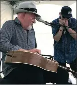  ?? ?? Sherman “Tank” Doucette of Kelowna added a bit of harmonica when he joined blues artist Harry Manx on Sunday afternoon for a song.