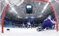  ?? THE ASSOCIATED PRESS ?? The puck shot by Ryan Donato of the United States sails past Jan Laco of Slovakia for a goal during the third period of Tuesday’s qualificat­ion round of the men’s hockey competitio­n at the 2018 Winter Olympics in Gangneung, South Korea.