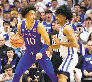  ?? JAMES CRISP AP ?? Kansas’ Jalen Wilson (left), who finished with 22 points and eight rebounds, is defended by Kentucky’s Jacob Toppin during the first half Saturday in Lexington, Ky.