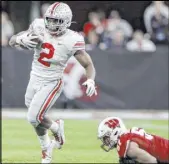  ?? Michael Conroy The Associated Press ?? Ohio State running back J.K. Dobbins leaves Wisconsin linebacker Jack Sanborn in his wake in the second half of the Buckeyes’ 34-21 win Saturday at Lucas Oil Stadium in Indianapol­is.