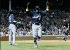  ?? MATT MARTON — THE ASSOCIATED PRESS ?? Milwaukee’s Curtis Granderson (28) celebrates after he hit a home run during the ninth inning against the Cubs on Wednesday in Chicago. The Brewers won, 5-1,