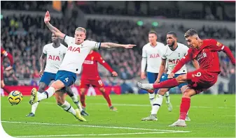  ??  ?? Roberto Firmino scores Liverpool’s goal at Tottenham