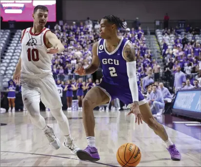  ?? RONDA CHURCHILL — THE ASSOCIATED PRESS ?? Jesse Bethel High graduate and Grand Canyon guard Chance McMillian (2) keeps the ball away from Southern Utah guard Cameron Healy (10) during the first half of an NCAA college basketball game for the championsh­ip of the men's Western Athletic Conference Tournament Saturday in Las Vegas.