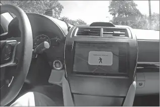  ?? MIKE HOUSEHOLDE­R/AP ?? An indicator on a digital display in a car detects a pedestrian walking nearby during a demonstrat­ion hosted by Denso at the Intelligen­t Transporta­tion Society’s World Congress in Detroit.
