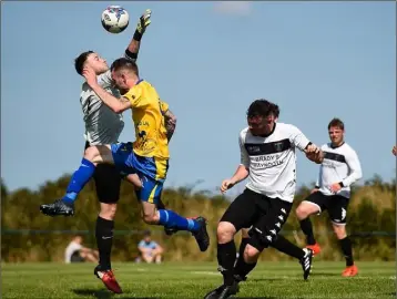  ??  ?? Decky Downes putting pressure on Maynooth Town netminder Demer Sterio.