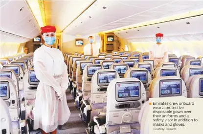  ?? Courtesy: Emirates ?? Emirates crew onboard wear a protective disposable gown over their uniforms and a safety visor in addition to masks and gloves.