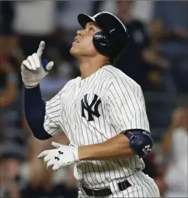  ?? ASSOCIATED PRESS FILE PHOTO ?? At left, Aaron Judge reacts after striking out against Cleveland on Wednesday. At right, Judge celebrates a home run against the New York Mets on Aug. 14 at Yankee Stadium.