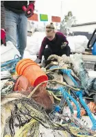  ??  ?? Volunteers help sort through marine debris at a recycling centre operated by the Ocean Legacy Foundation.