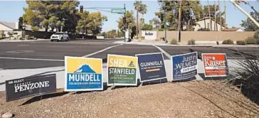  ?? DARIO LOPEZ-MILLS/AP ?? Electoral signs line an intersecti­on during August in Phoenix. America’s suburbs are poised to decide not just theWhite House but the contours of the debate over multiple issues.