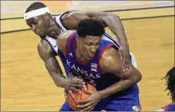  ?? ORLIN WAGNER ?? Kansas forward David McCormack (33) is fouled by Kansas State forward Makol Mawien, left, during the second half of a game in Manhattan, Kan., Saturday, Feb. 29, 2020.