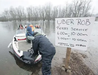  ?? ANDREW VAUGHAN / THE CANADIAN PRESS ?? Rob Dekany, known as Uber Rob, ferries stranded passengers at Darlings Island, N.B., on Thursday as the Kennebecas­is River flooded the only road into the community. Dekany has refused to accept any payment.