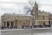  ??  ?? About 2,000 people lined up outside Toronto’s Our Lady of Lourdes Catholic Church Sunday afternoon to venerate the relic.