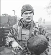  ?? EVGENIY MALOLETKA/THE ASSOCIATED PRESS ?? Ukrainian national guard soldiers stand in position at the checkpoint in Berdyansk, on the south coast of the Azov sea in eastern Ukraine, Nov. 27. Russia and Ukraine traded blame after Russian border guards on Nov. 25 opened fire on three Ukrainian navy vessels and eventually seized them and their crews. The incident put the two countries on war footing and raised internatio­nal concern.