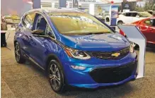  ?? AP FILE PHOTO/ GENE J. PUSKAR ?? A 2020 Chevrolet Bolt EV is displayed at the 2020 Pittsburgh Internatio­nal Auto Show in Pittsburgh. Thursday, General Motors said a pending breakthrou­gh in battery chemistry will cut the price of its electric vehicles so they equal those powered by gasoline within five years.