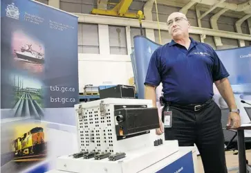  ?? WAYNE CUDDINGTON /OTTAWA CITIZEN ?? Following a brief update, lead investigat­or Rob Johnston of the Transporta­tion Safety Board of Canada stands beside the event recorder retrieved from the Via passenger train involved in Wednesday morning’s collision with an OC Transpo double-decker bus that resulted in the death of six people. The TSB found nothing wrong with the train or the track.