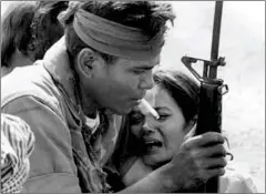 ?? JEAN-JACQUES CAZAUX/AFP ?? In 1975, a soldier comforts a woman whose relatives were found murdered in a rice field near Phnom Penh.
