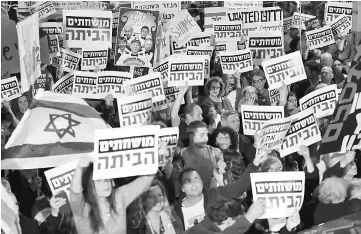  ??  ?? Israelis take part in a demonstrat­ion titled the ‘March of Shame’, as they protest against Netanyahu and government corruption in the coastal city of Tel Aviv. — AFP photo