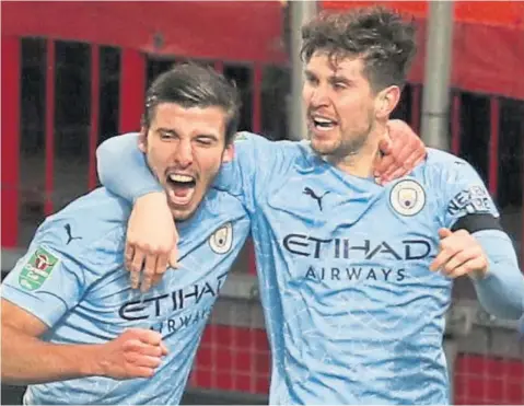  ??  ?? Man City star John Stones(right) celebrates with Ruben Dias after scoring the opening goal against Man United.