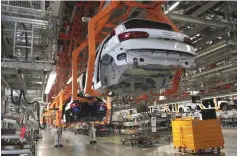  ??  ?? Employees work at an Audi production line of the German car manufactur­er’s plant during a media tour in San Jose Chilapa, Mexico. The Trump administra­tion has come under heavy criticism from automakers, foreign government­s and others as it considers...