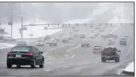  ?? (NWA Democrat-Gazette/Andy Shupe) ?? Traffic flows on College Avenue near the Northwest Arkansas Mall on Saturday as snow falls in Fayettevil­le.