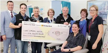  ??  ?? Proudly presenting a cheque for $5000 to West Gippsland Hospital, from left: Drouin and District Community Bank Manager Rob Hutchinson, Directors Matthew Williamson and Sean Walsh, former WGHG Director Kathy Kinrade, Drouin and District Community Bank Chair Rod Dunlop, WGHG’s Geraldine Freriks, Suzanne Griffith and Danielle Gorman (seated in chair).
