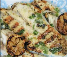  ?? MELISSA D’ARABIAN VIA AP ?? This photo shows grilled halibut with butter caper herb sauce in d’ArabianFIS­H Bethesda, Md. This dish is from a recipe by Melissa .