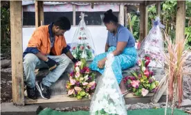  ??  ?? Fa’aoso Tuivale and her husband, Tuivale Luamanuvae Puelua sit on their children’s graves in Lauli’i, Samoa. Photograph: Misiona Simo/Samoa Observer