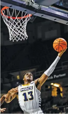  ?? STAFF PHOTO BY TROY STOLT ?? UTC guard Malachi Smith drives to the basket during a home game against Tennessee Tech on Tuesday. Smith scored 20 points and hit the winning shot as the Mocs defeated host VCU on Saturday.