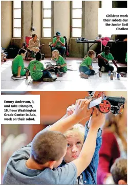  ??  ?? Emory Anderson, 9, and Jake Clampitt, 10, from Washington Grade Center in Ada, work on their robot. Children work on their robots during the Junior Botball Challenge.