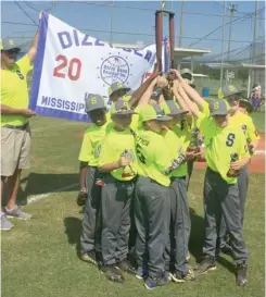  ?? (Photo by Robbie Faulk, SDN) ?? The Starkville 10-year-old Dizzy Dean All-Stars celebrate with the championsh­ip trophy and banner after winning the South State championsh­ip in West Point Sunday.