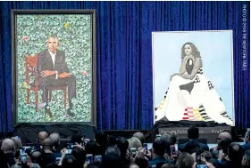  ??  ?? The portraits of Barack and Michelle Obama during their unveiling at the National Portrait Gallery in Washington.