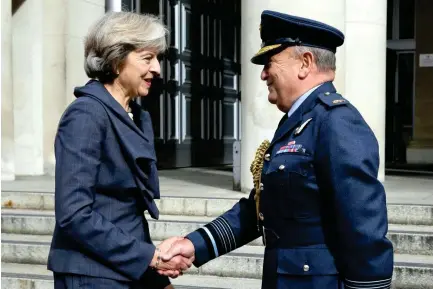  ??  ?? British Prime Minister Theresa May shakes hands with Air Chief Marshal Stuart Peach in London. (File photo/Reuters)