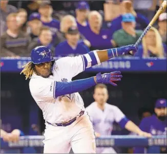  ?? Tom Szczerbows­ki Getty Images ?? VLADIMIR GUERRERO JR. gets his first major league hit on Friday night against Oakland. The Blue Jays didn’t call up Guerrero until last week, keeping him under club control a year longer.