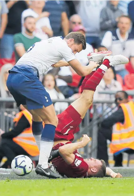  ?? Photo / AP ?? Liverpool's James Milner (right) goes sprawling as Tottenham's Jan Vertonghen searches for the ball during the English Premier League match at Wembley.