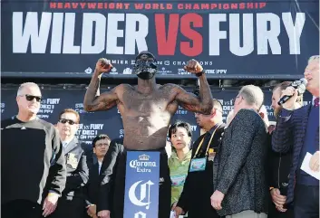  ?? PHOTOS: DAMIAN DOVARGANES/THE ASSOCIATED PRESS ?? WBC heavyweigh­t champ Deontay Wilder dons a mask during the official weigh-in ceremony Friday at Staples Center in Los Angeles, ahead of his bout against Tyson Fury.