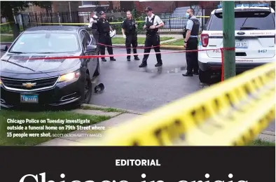  ?? SCOTT OLSON/GETTY IMAGES ?? Chicago Police on Tuesday investigat­e outside a funeral home on 79th Street where 15 people were shot.