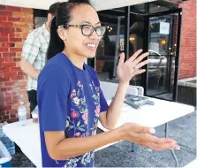  ??  ?? Tina Kennedy stops by a cannabis pop-up market on Sunday. Organizers say they get positive feedback from customers.