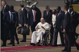  ?? BEN CURTIS — THE ASSOCIATED PRESS ?? Pope Francis talks to South Sudan's President Salva Kiir, center-right, after arriving at the airport in Juba, South Sudan, on Friday.